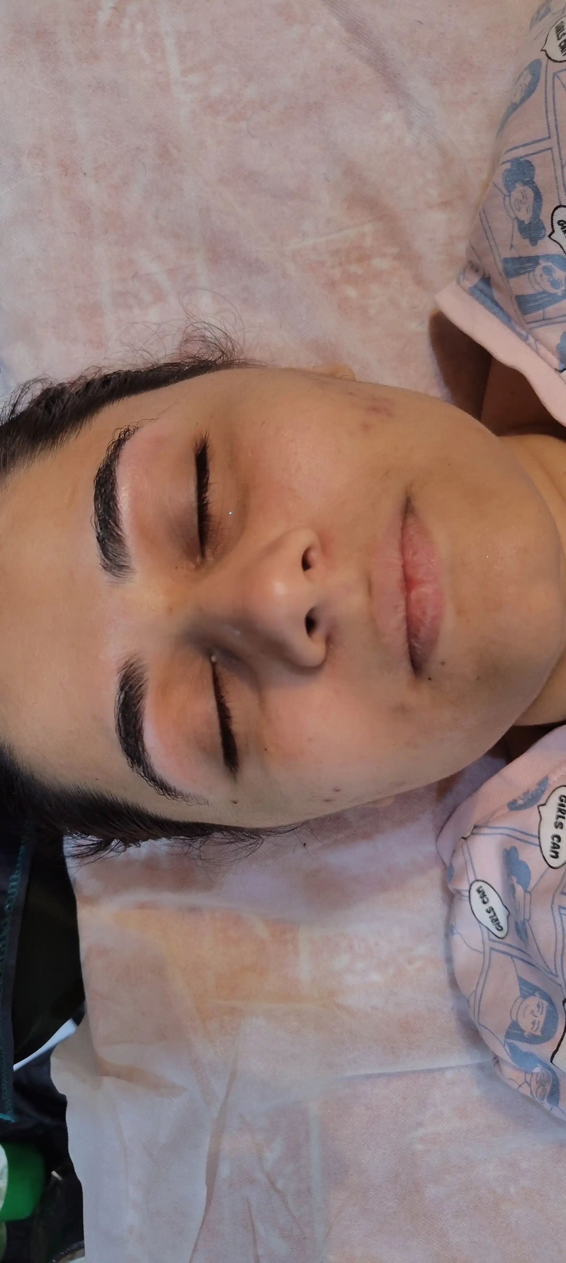 Client resting with eyes closed at the start of a home facial appointment in Jaipur